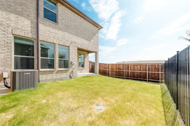 a backyard of a house with wooden fence