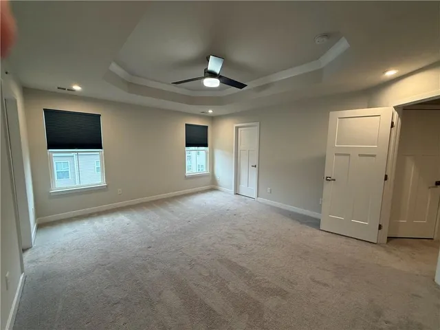 a view of a livingroom with an empty space and a ceiling fan