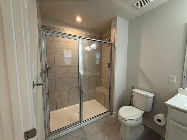 a bathroom with a shower a toilet and sink