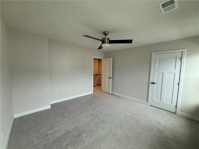 a view of a livingroom with a ceiling fan and window