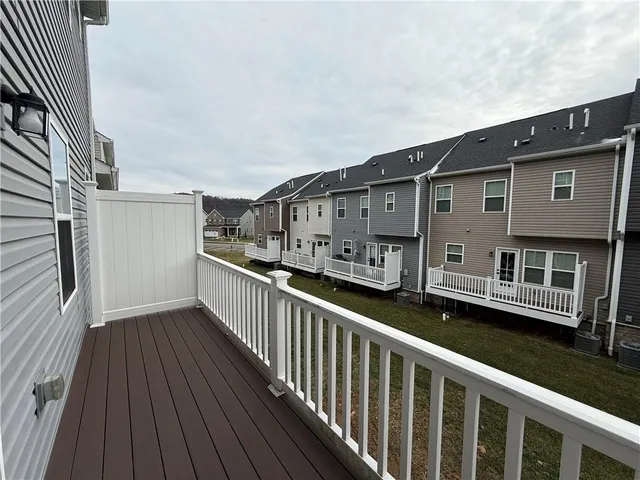 a view of a house with wooden deck