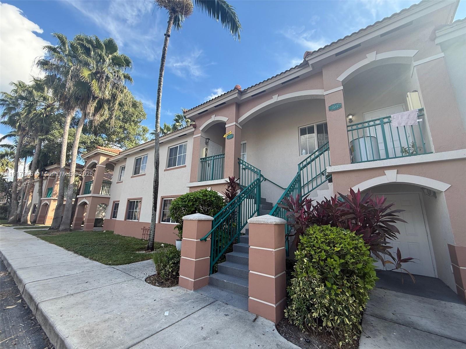 2911 Southeast 13th Road, Unit 20240 Homestead, FL 33035 - Photo 1 of 28 a front view of a house with garden