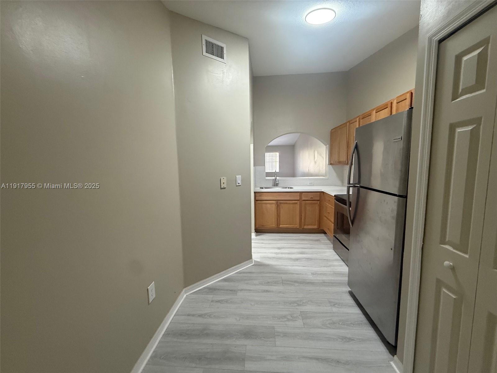 2911 Southeast 13th Road, Unit 20240 Homestead, FL 33035 - Photo 11 of 28 a kitchen with a refrigerator and a sink