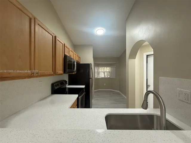 a kitchen with a sink and a refrigerator