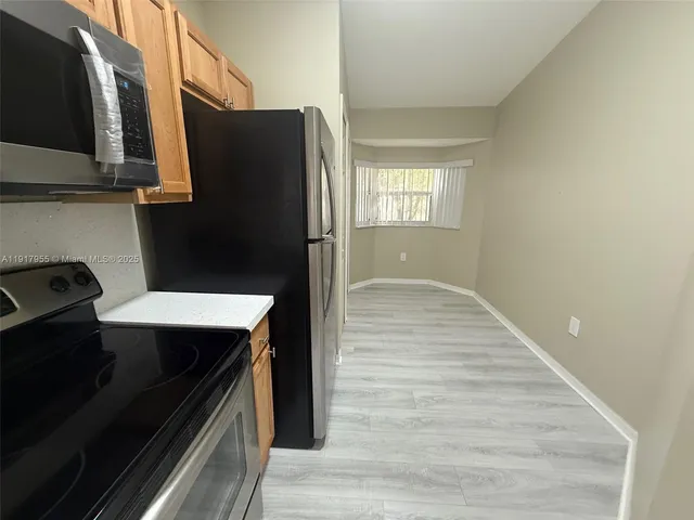 a kitchen with a sink and a refrigerator