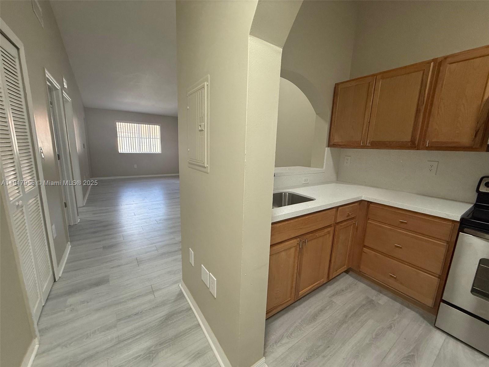 2911 Southeast 13th Road, Unit 20240 Homestead, FL 33035 - Photo 17 of 28 a kitchen with cabinets and wooden floor