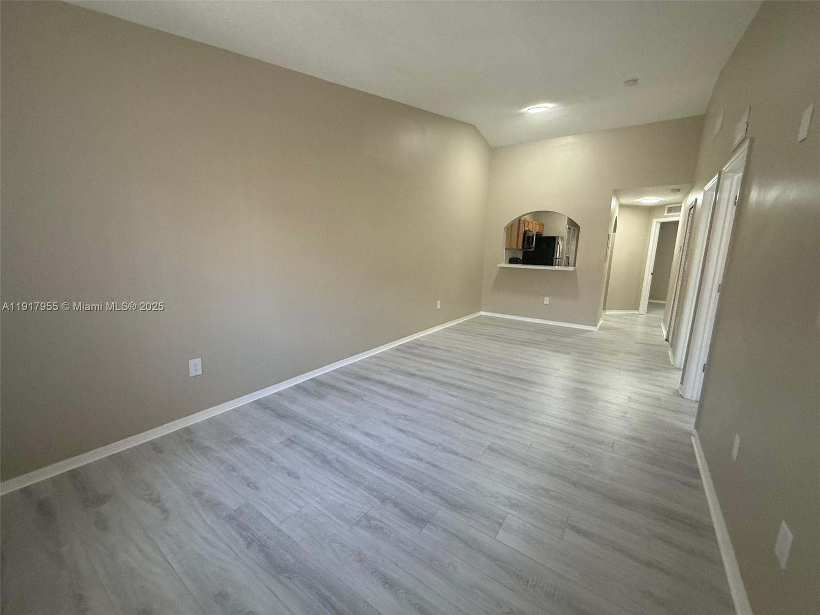 2911 Southeast 13th Road, Unit 20240 Homestead, FL 33035 - Photo 7 of 28 a view of a big room with wooden floor and a window
