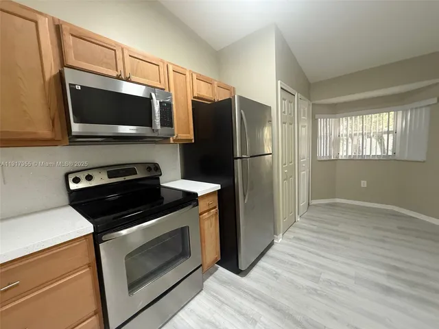 a kitchen with a stove microwave and refrigerator