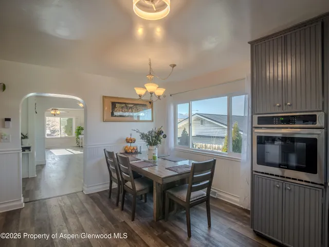 a view of a dining room with furniture window and wooden floor