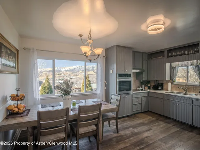 a kitchen with sink cabinets and dining table