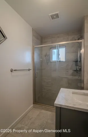 a bathroom with a sink and mirror