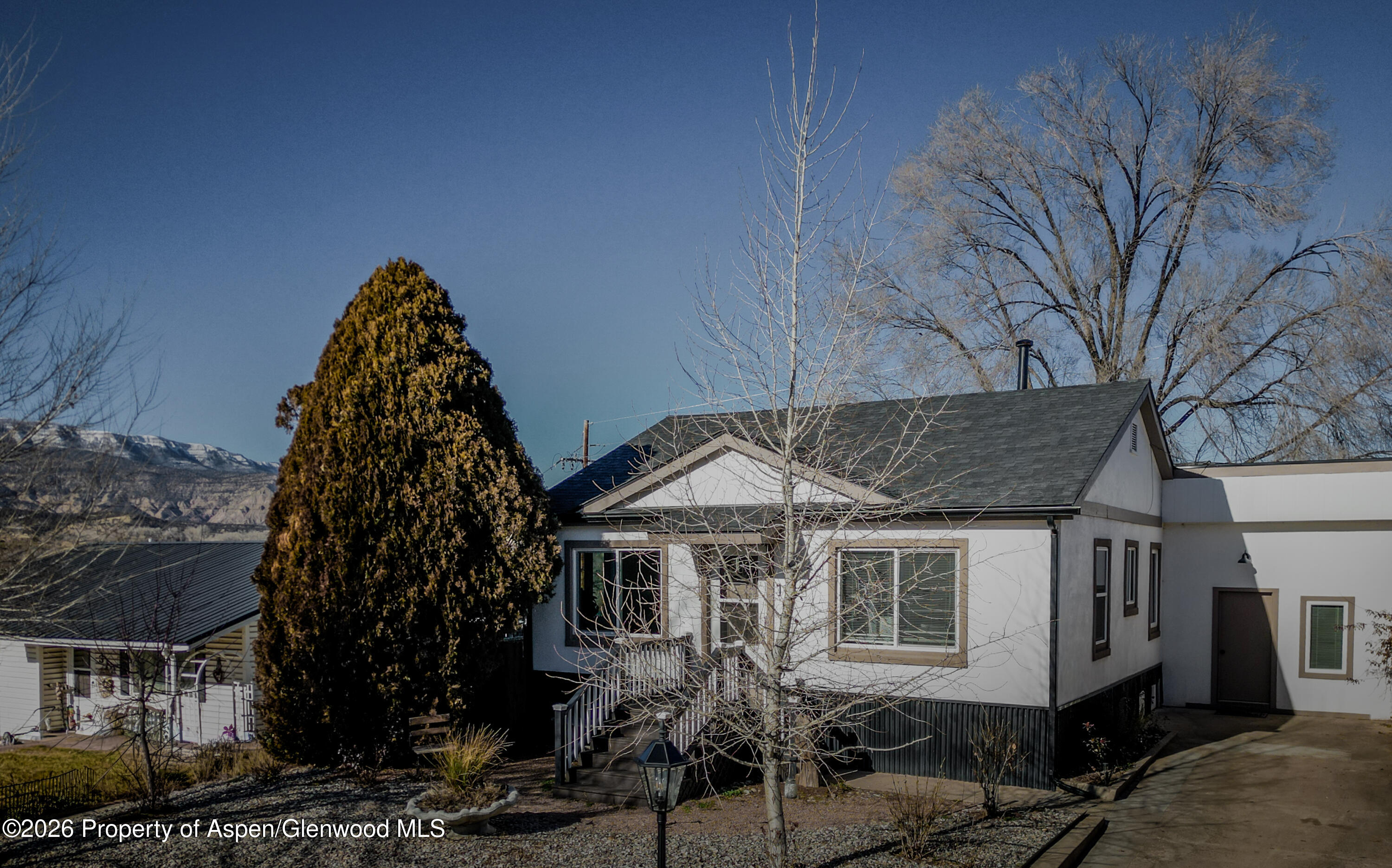 326 East 10th Street Rifle, CO 81650 - Photo 2 of 39 a front view of a house with a yard