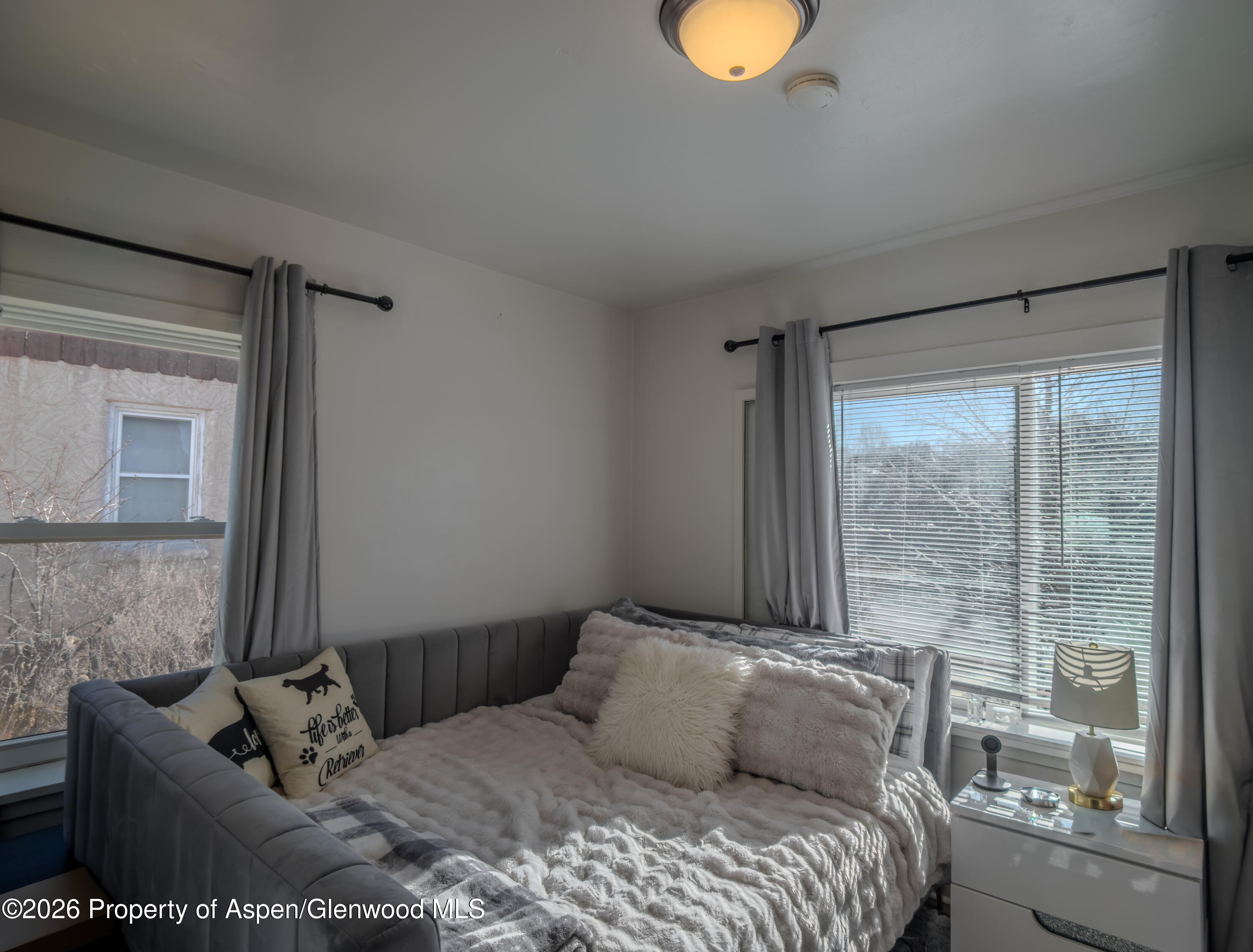 326 East 10th Street Rifle, CO 81650 - Photo 23 of 39 a bedroom with a bed and window
