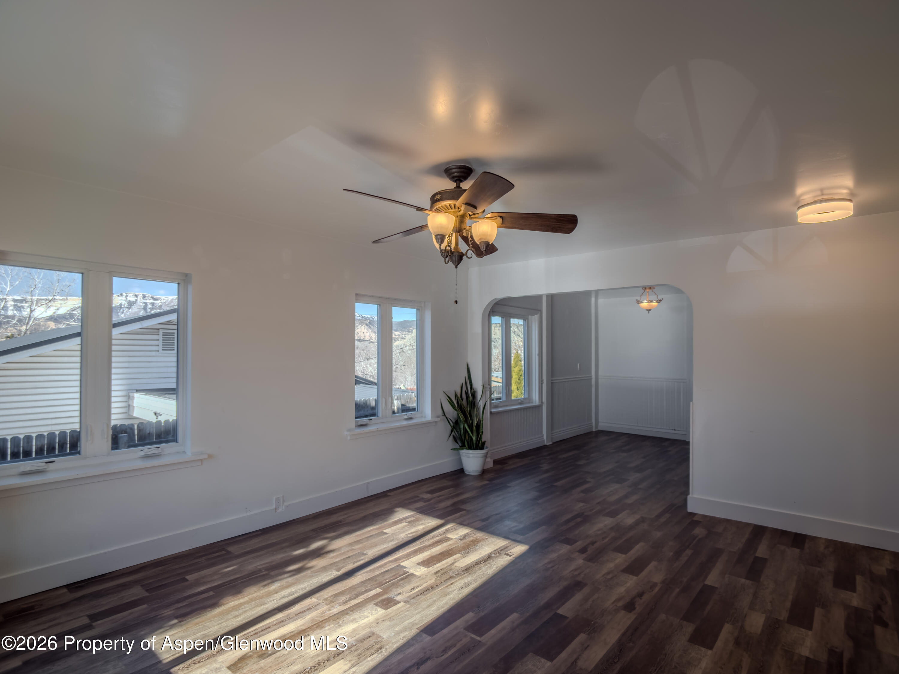 326 East 10th Street Rifle, CO 81650 - Photo 3 of 39 wooden floor in an empty room with a window
