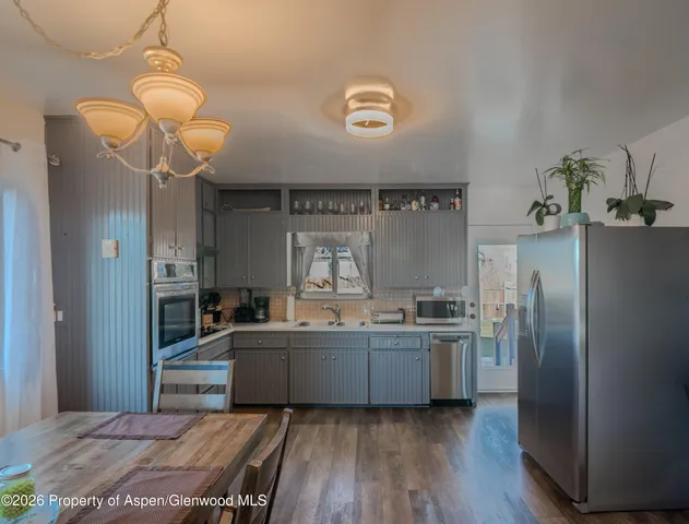 a kitchen with stainless steel appliances granite countertop a refrigerator and a stove top oven
