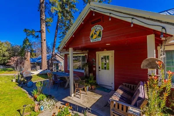 a dining hall with stainless steel appliances granite countertop a dining table and chairs