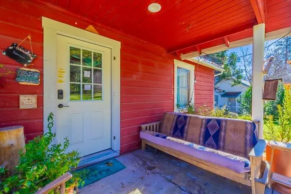 a living room with fireplace furniture and a large window