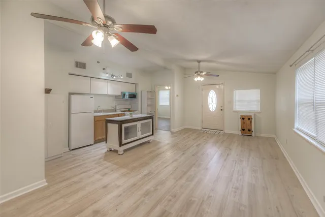 a kitchen with kitchen island white cabinets and stainless steel appliances