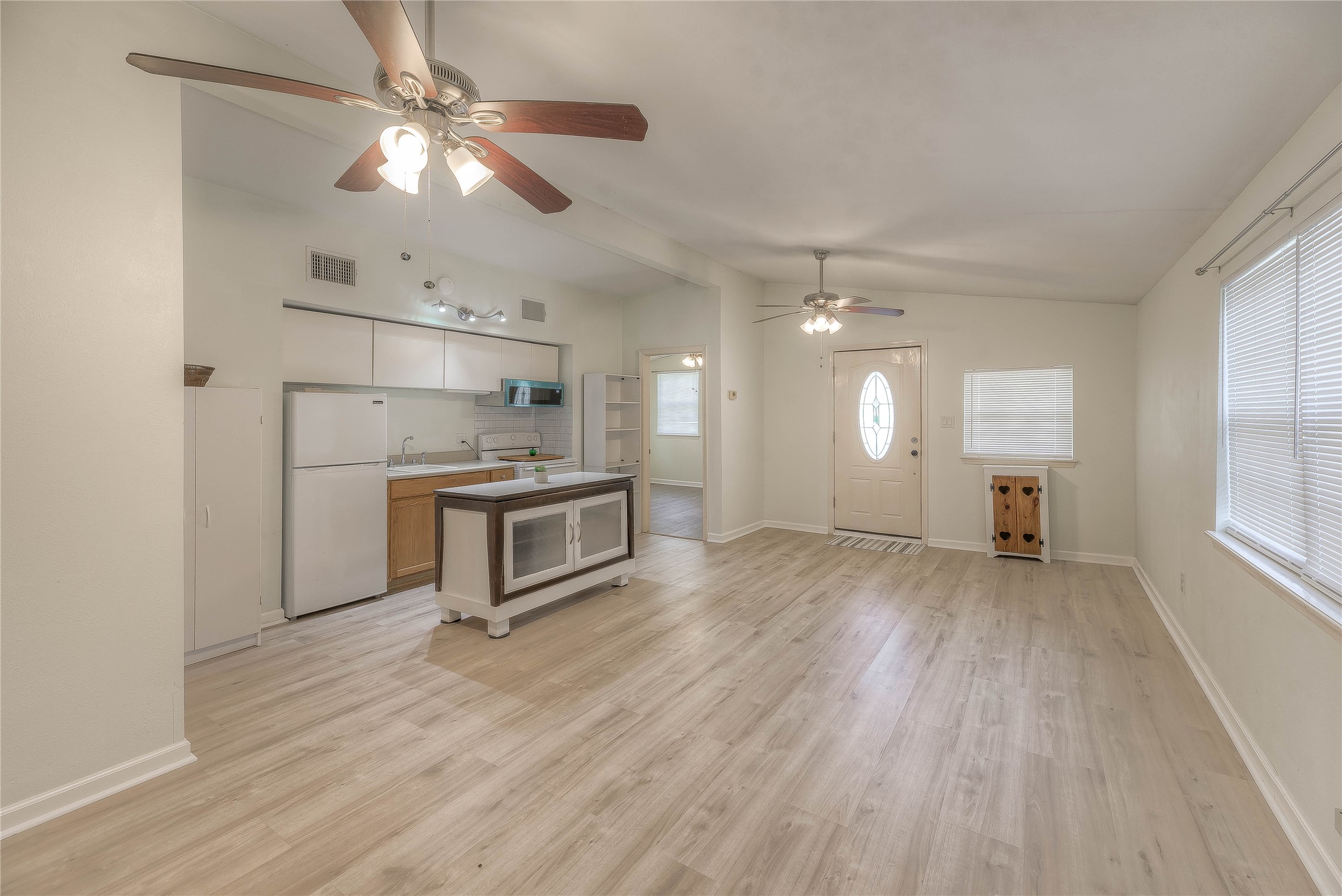 28609 Netawake Court Point Blank, TX 77364 - Photo 3 of 32 a kitchen with kitchen island white cabinets and stainless steel appliances