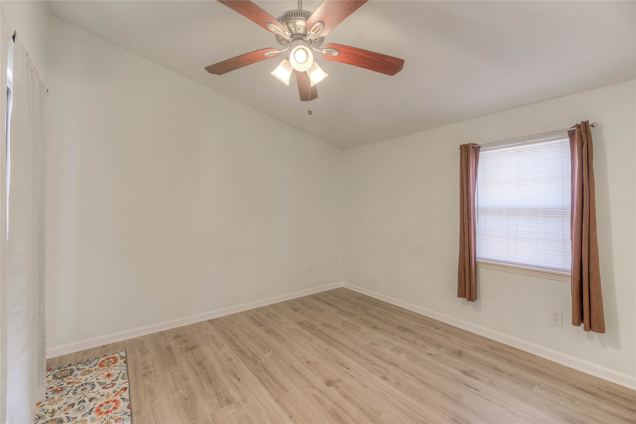 28609 Netawake Court Point Blank, TX 77364 - Photo 7 of 32 an empty room with a ceiling fan and wooden floor