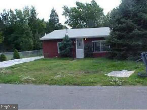 a view of a house with a yard and a garden