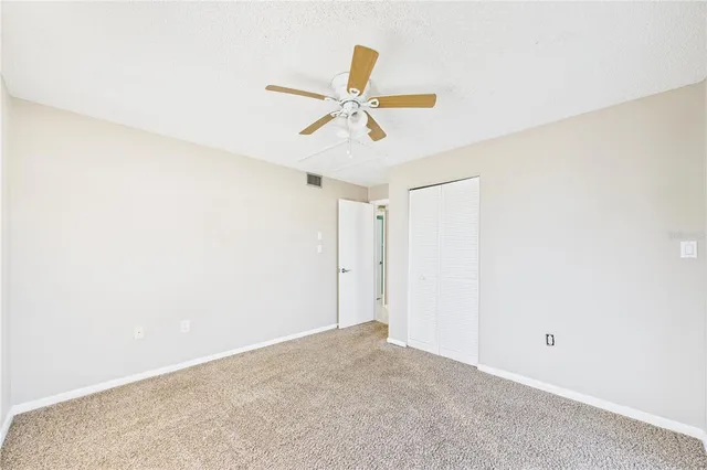 a view of a ceiling fan and a window