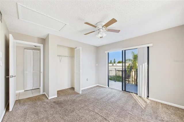 a view of a livingroom with a ceiling fan and window