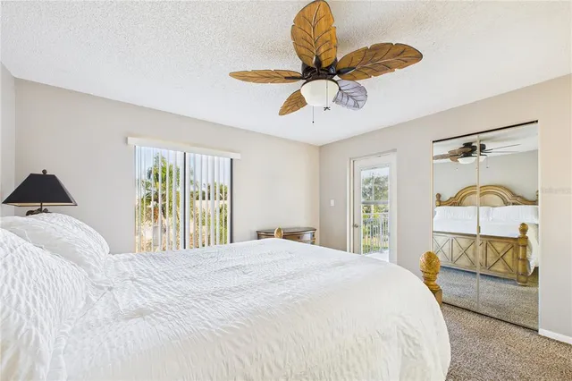 a bedroom with a bed and dresser with mirror
