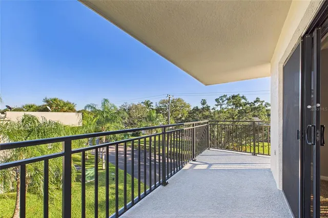 a view of a balcony with wooden floor and outdoor space