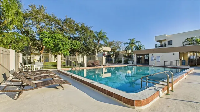 a view of backyard with swimming pool and outdoor seating
