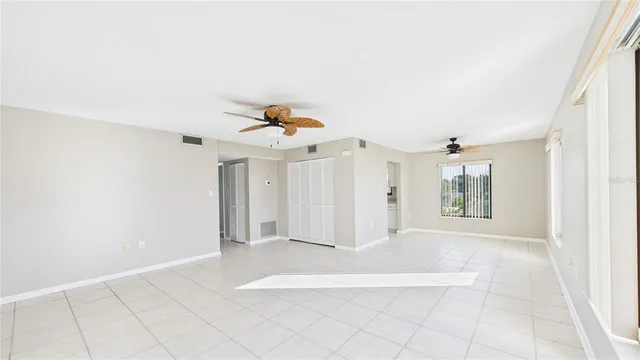 a view of a livingroom with wooden floor and a ceiling fan