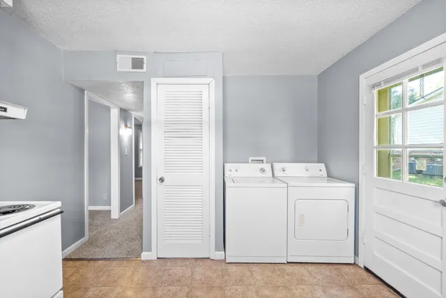 a view of storage and utility room with washer and dryer