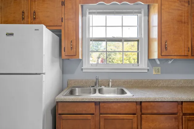 a view of a kitchen with a sink and a window