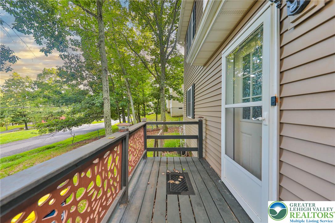 2114 Lakeview Road Bushkill, PA 18324 - Photo 61 of 83 An elevated wood balcony provides a peaceful outdoor retreat overlooking the mature surrounding trees.