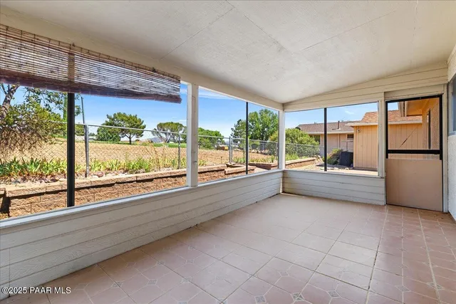 a view of room with furniture and large windows