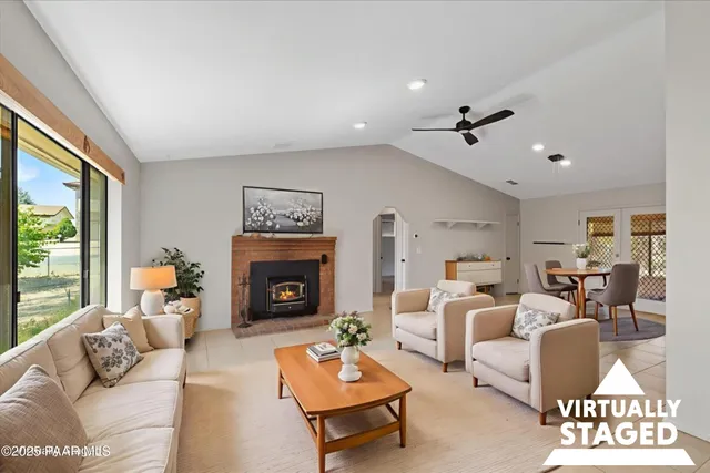 a living room with furniture fireplace and window