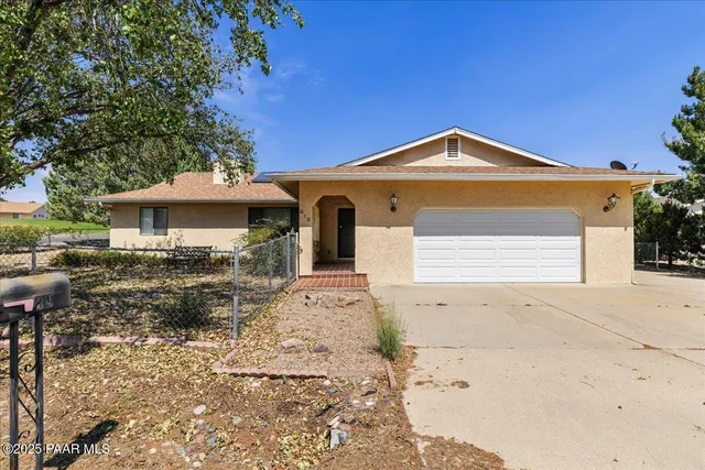 an empty room with windows and fireplace