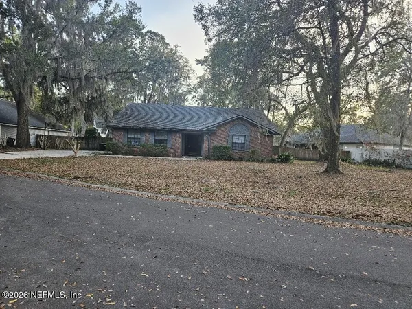 a front view of house with a garden