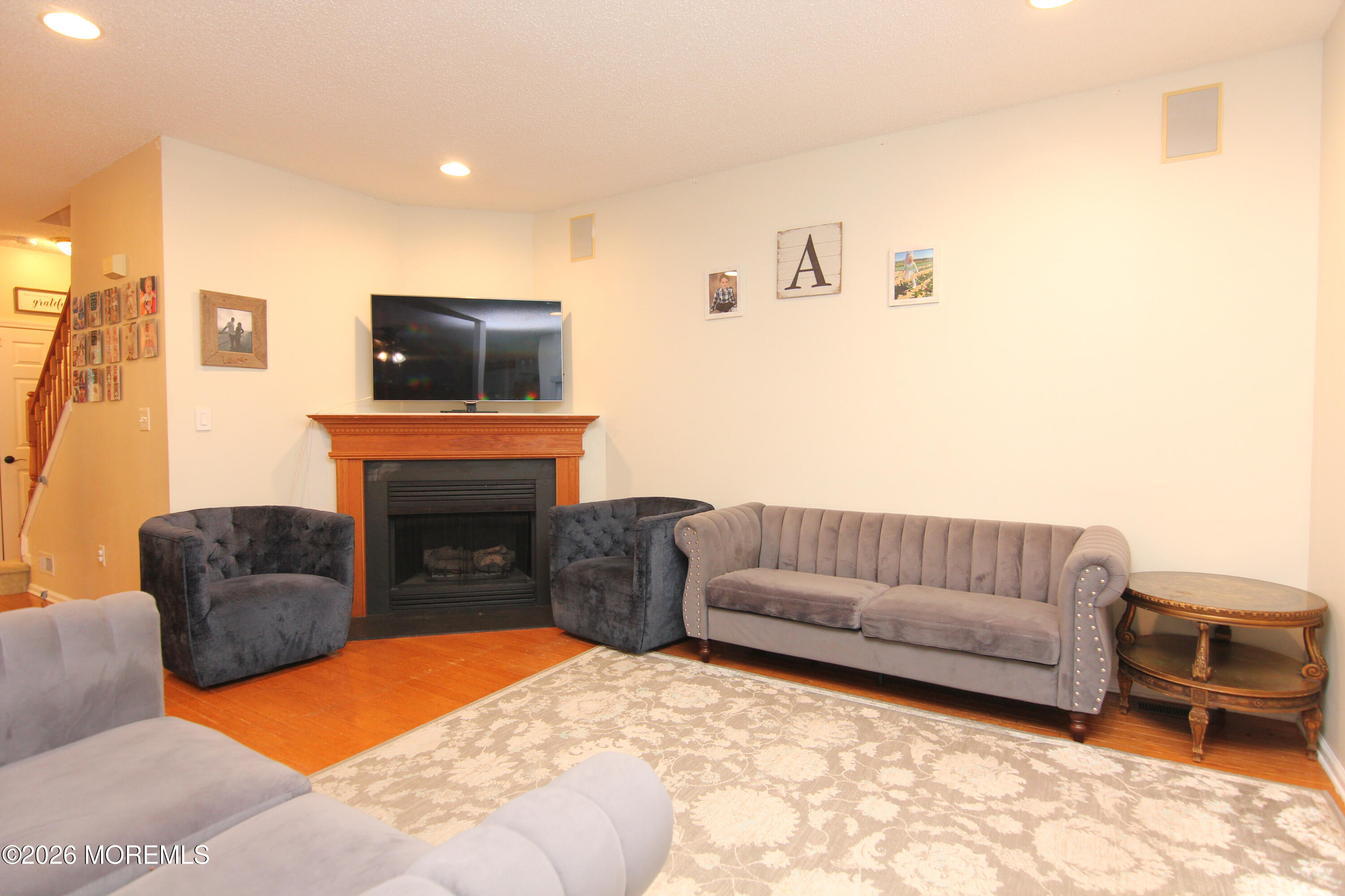 33 Austin Street Tinton Falls, NJ 07712 - Photo 42 of 46 a living room with furniture a flat screen tv and a fireplace