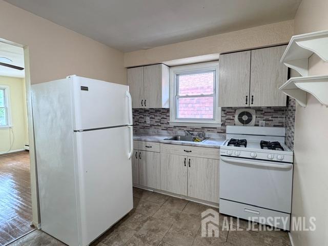 760 Mary Street, Unit B Perth Amboy, NJ 08861 - Photo 6 of 10 a white refrigerator freezer sitting inside of a kitchen