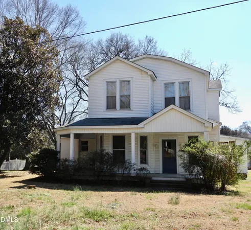 an empty room with wooden floor and a window