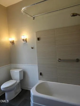 a bathroom with a toilet and a bathtub