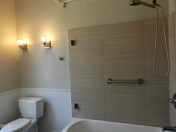 a bathroom with a toilet and shower