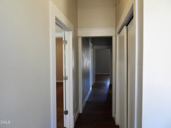 a view of a hallway with wooden floor