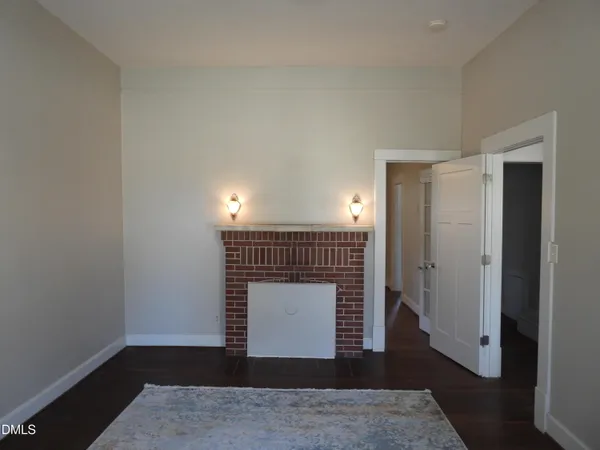 a small space with wooden floor and a window