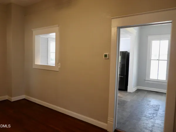 an empty room with wooden floor and a window