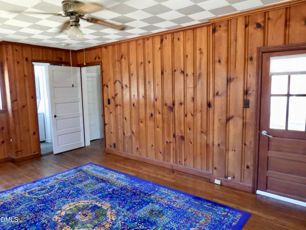 a view of a room with wooden floor closet and windows
