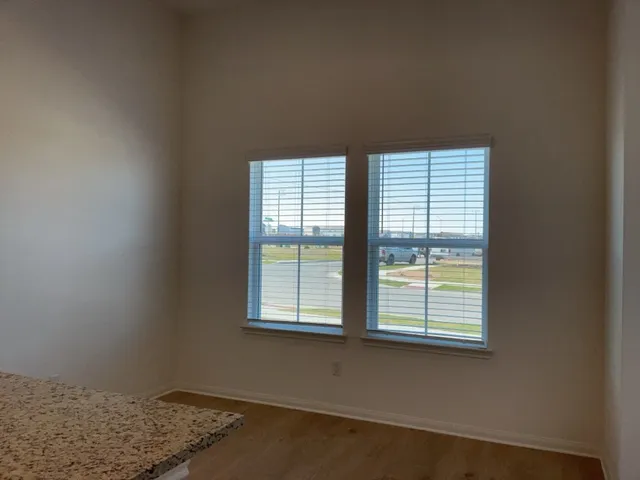 a kitchen with a refrigerator a microwave a sink and cabinets