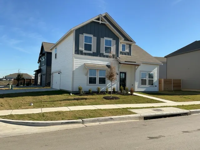 a view of a house with swimming pool and a fire pit