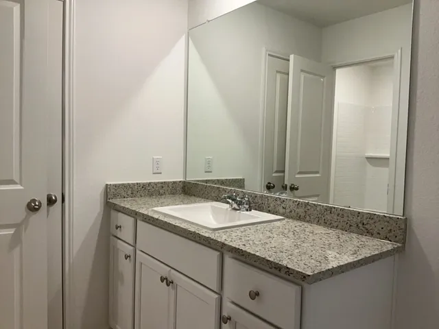 a white toilet sitting next to a bath tub